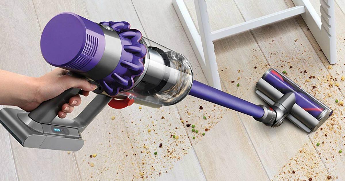 hand held Dyson Cyclone V10 Vacuum cleaning dirt from a floor 
