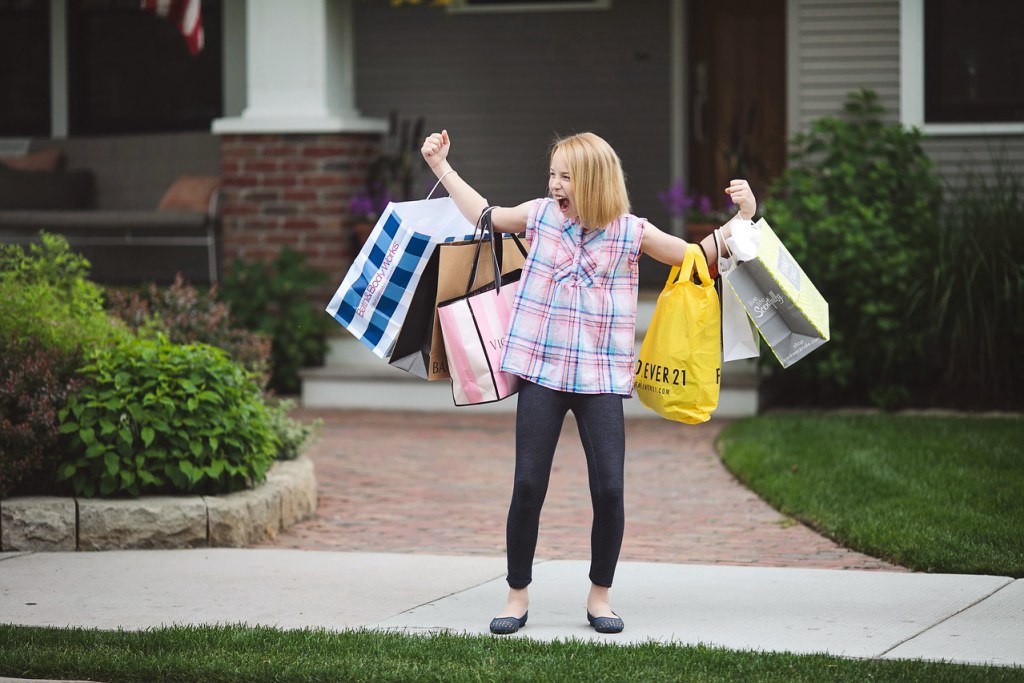 girl with tons of shopping bags outside