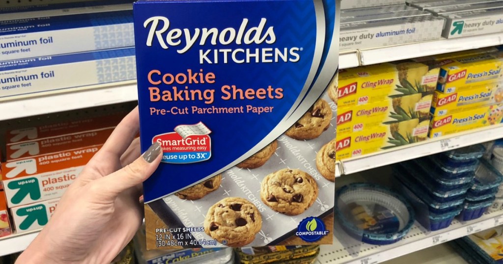 hand holding package of Reynolds cookie baking sheets