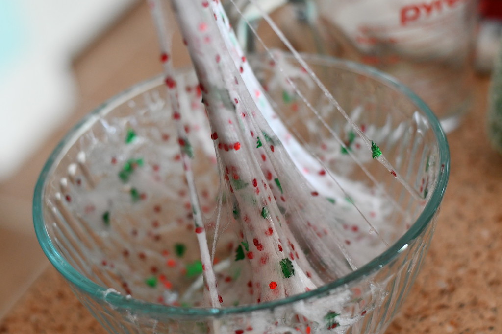 pulling Christmas slime out of bowl