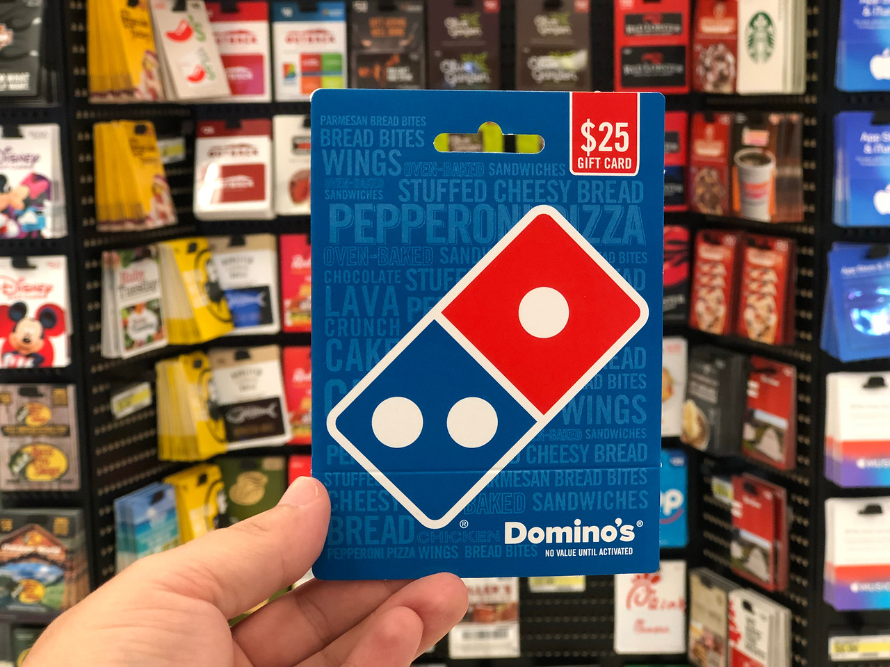 hand holding a $25 domino's gift card