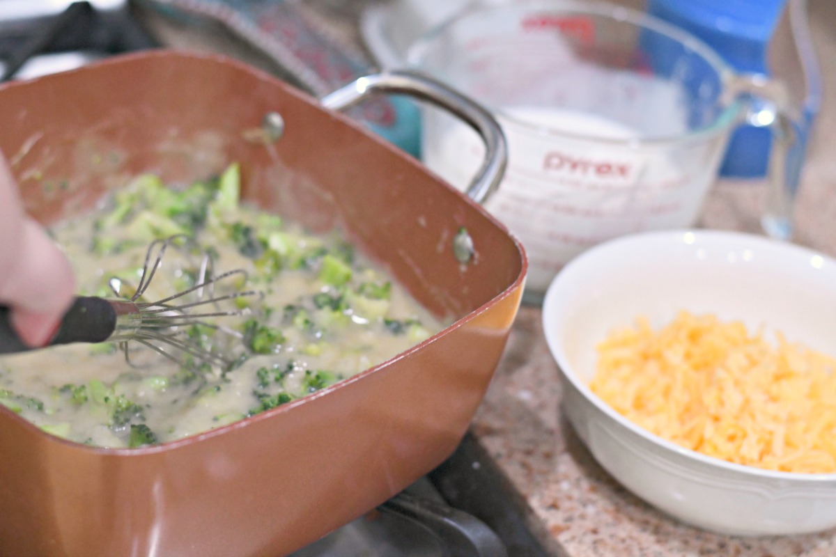 broccoli cheddar cobbler ingredients being cooked on the stove