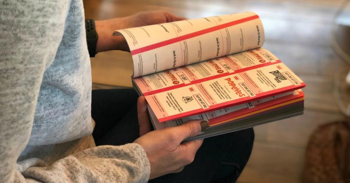 woman looking through entertainment book