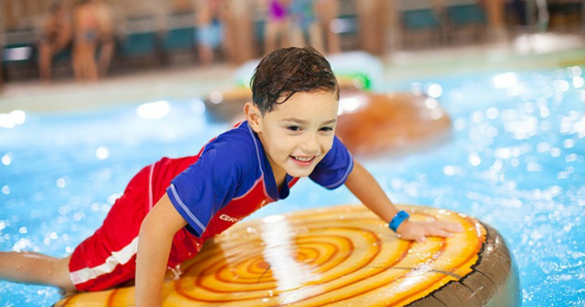 boy in pool on raft