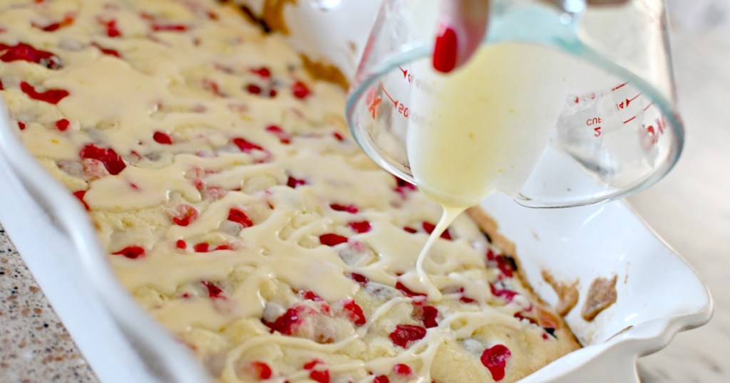 pouring glaze on cranberry christmas cake