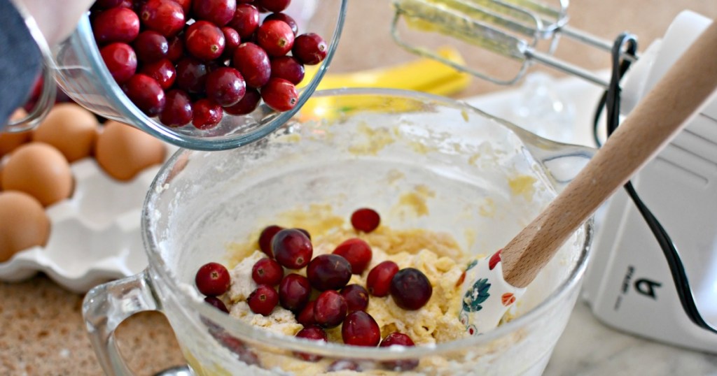 pouring in cranberries to christmas cake