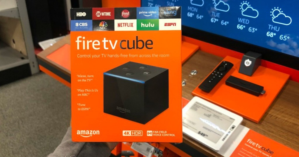 holding fire TV cube in box