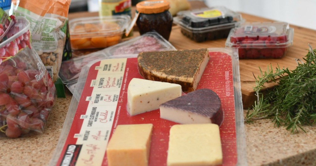 Cheese platter with fruits and more on tray 