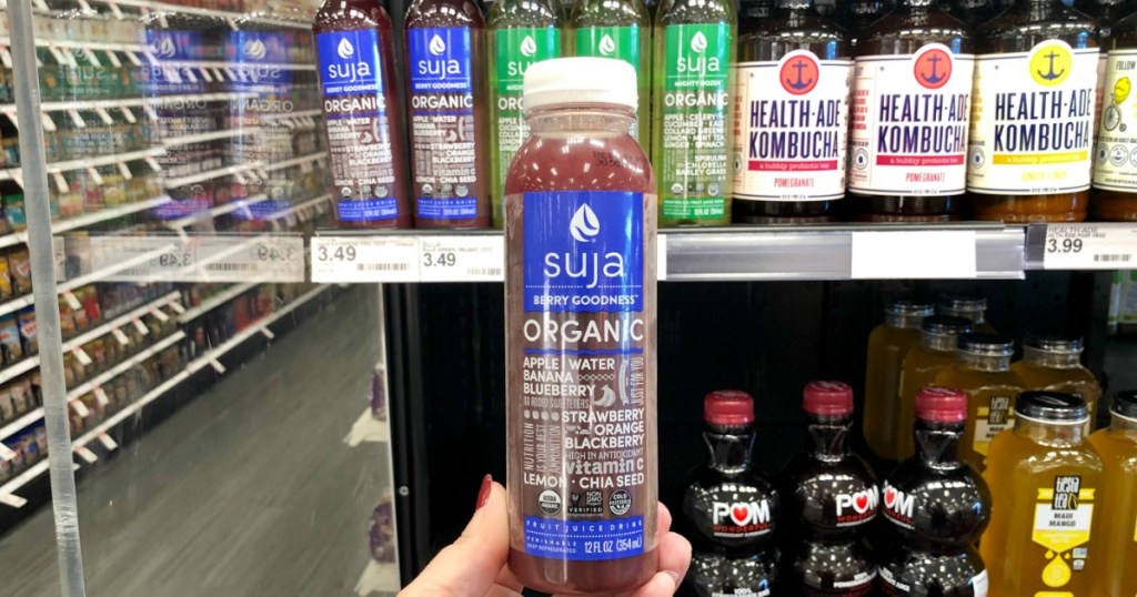 hand holding suja organic juice