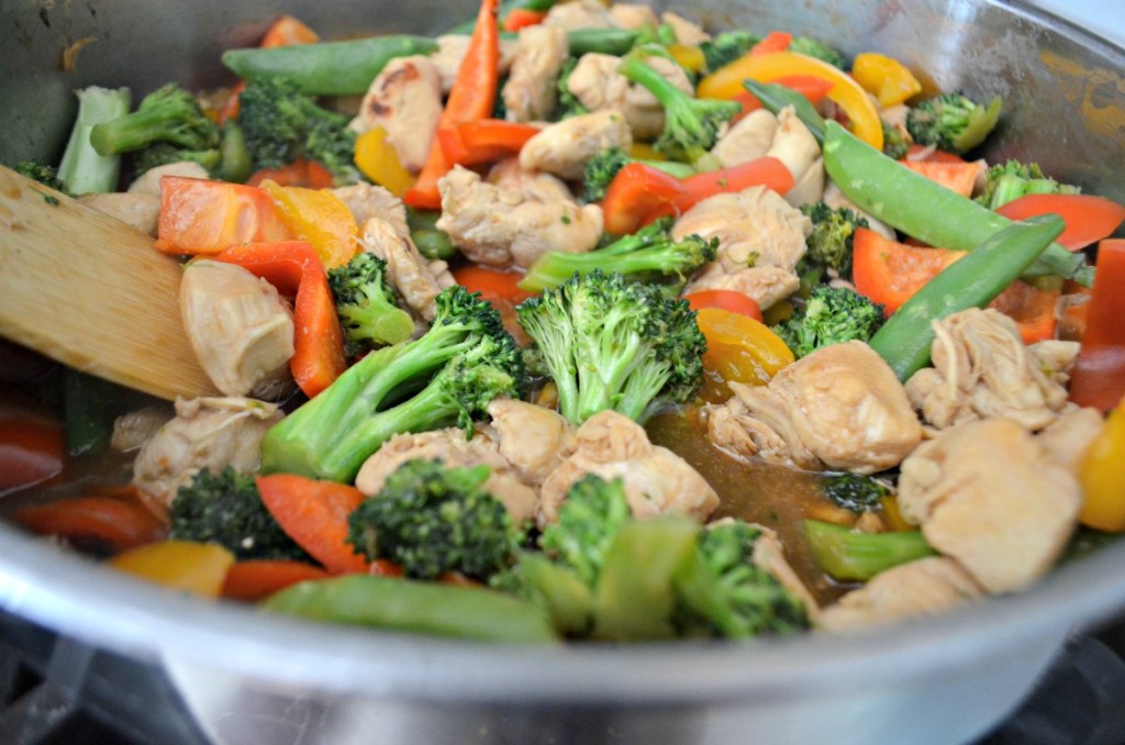chicken stir-fry on the stove with veggies 