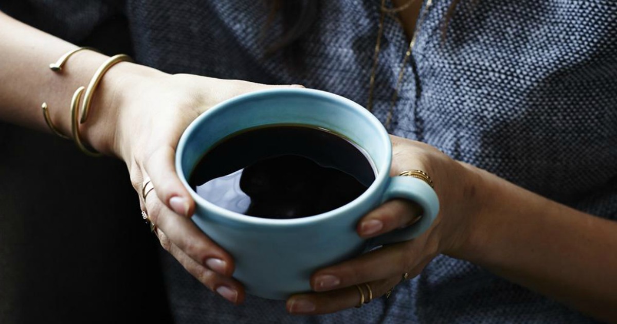 woman holding a cup of coffee