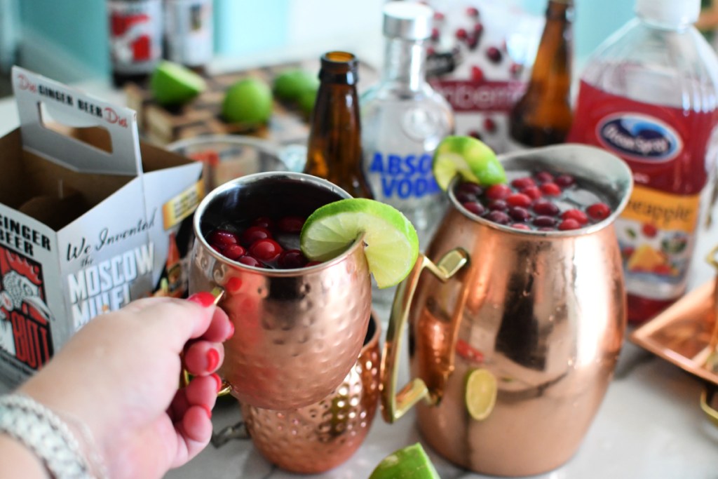 holding a cranberry moscow mule
