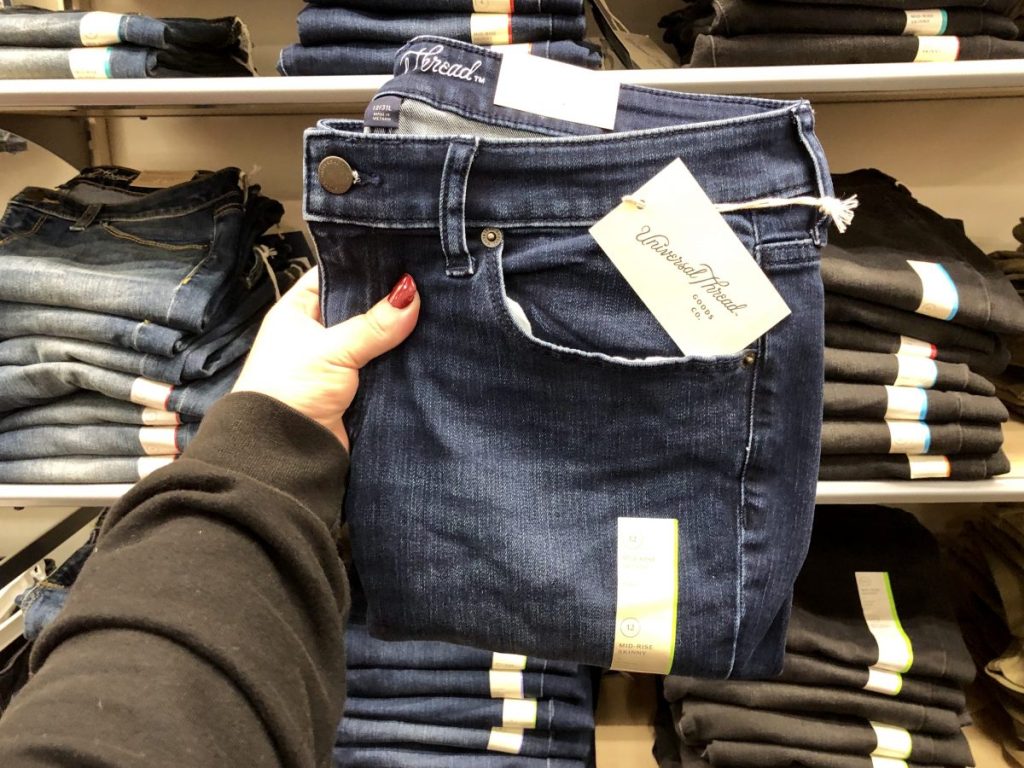 hand holding up pair of Universal Thread jeans