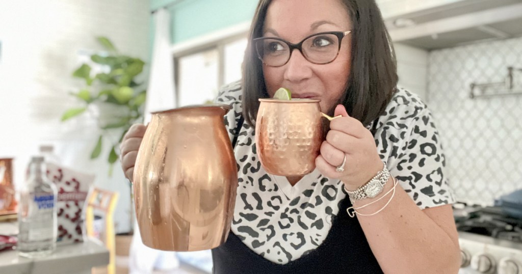 woman drinking a cranberry moscow mule punch