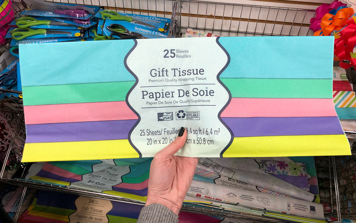 hand holding a pack of colorful tissue paper