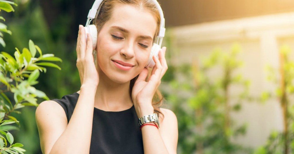 woman with headphones on her head outside