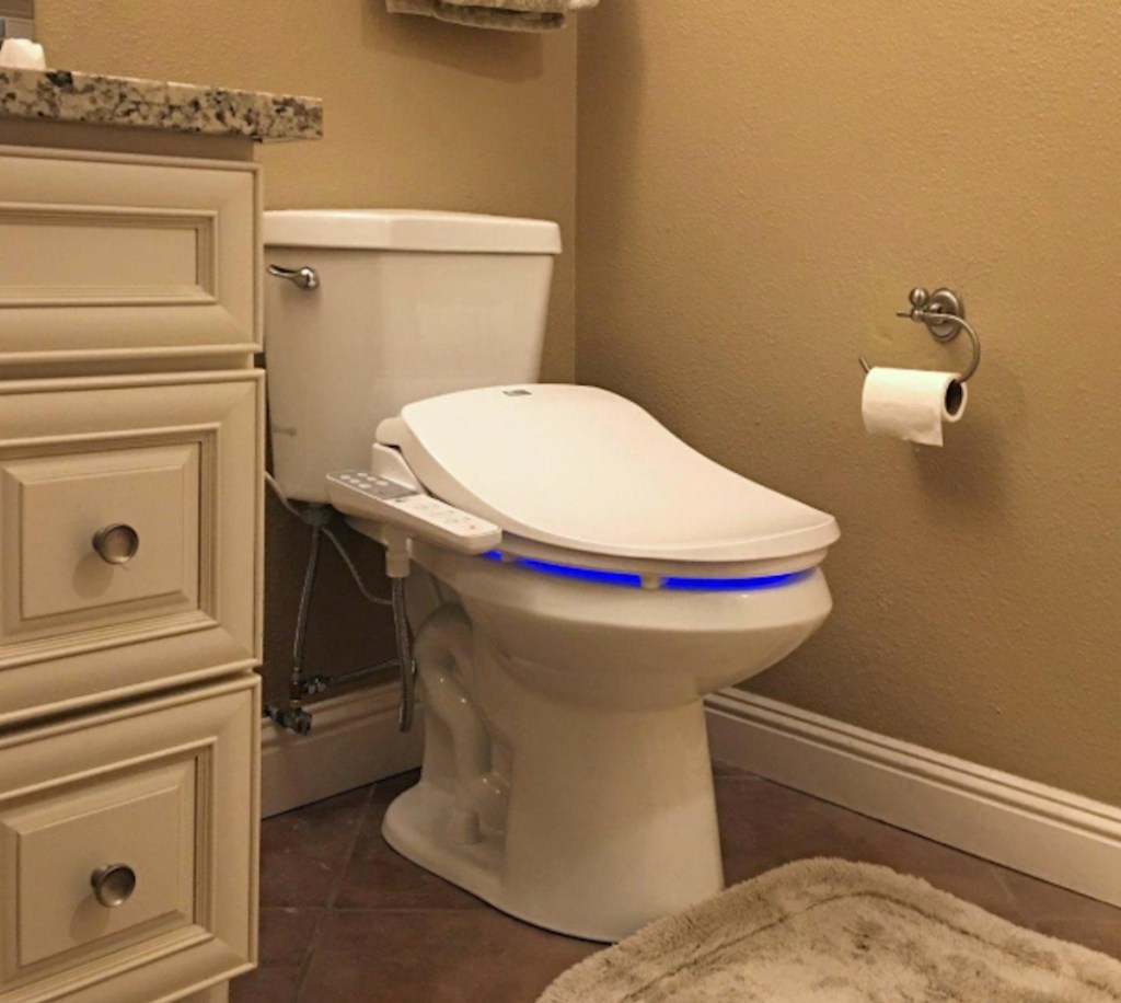 white toilet in bathroom next to vanity sink