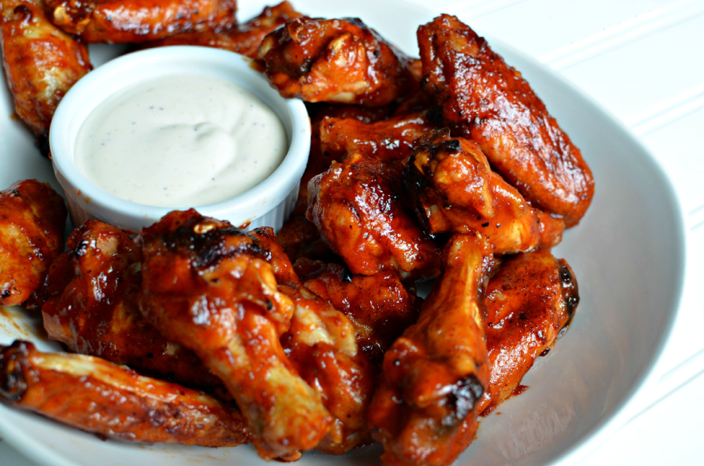 honey bbq chicken wings on a plate with ranch dressing 