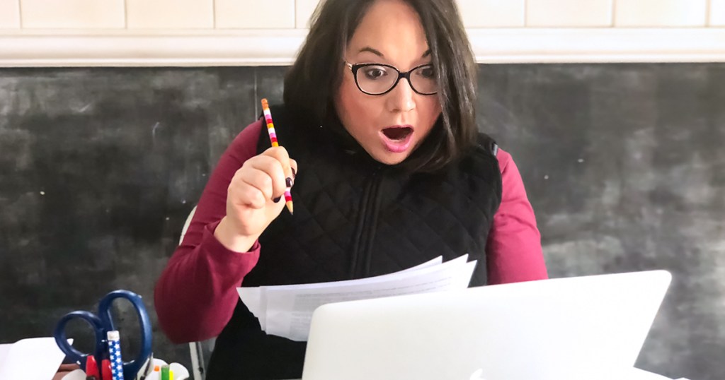 lina working on taxes with shocked look on her face