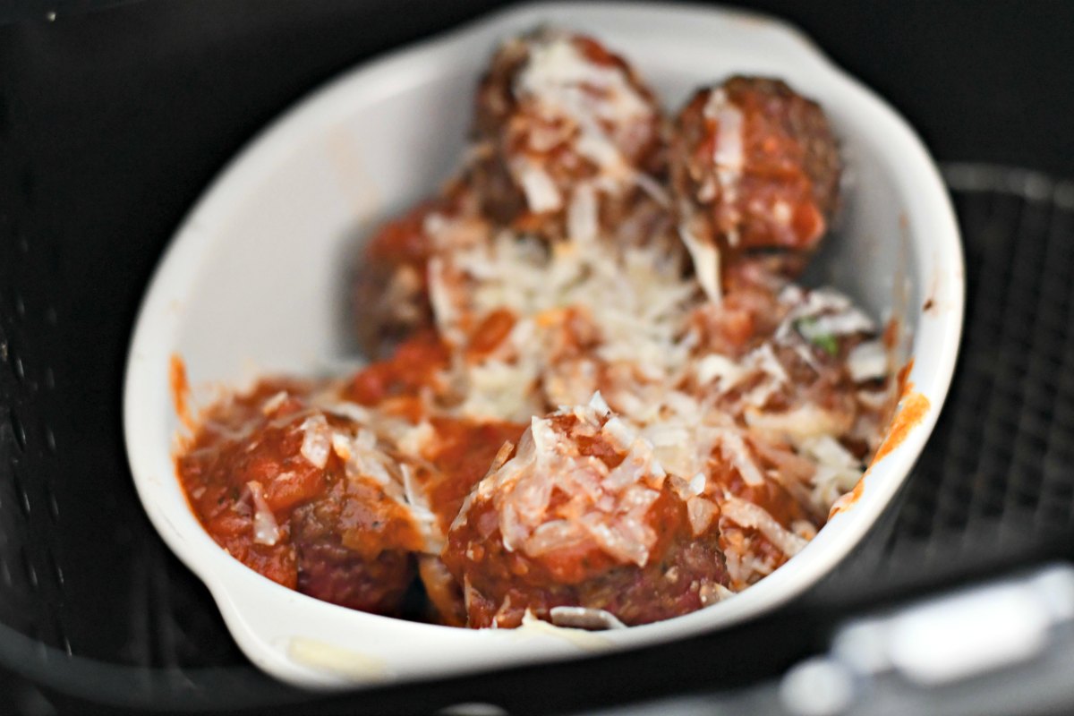 easy air fryer Parmesan meatballs cooked and in a bowl with added cheese