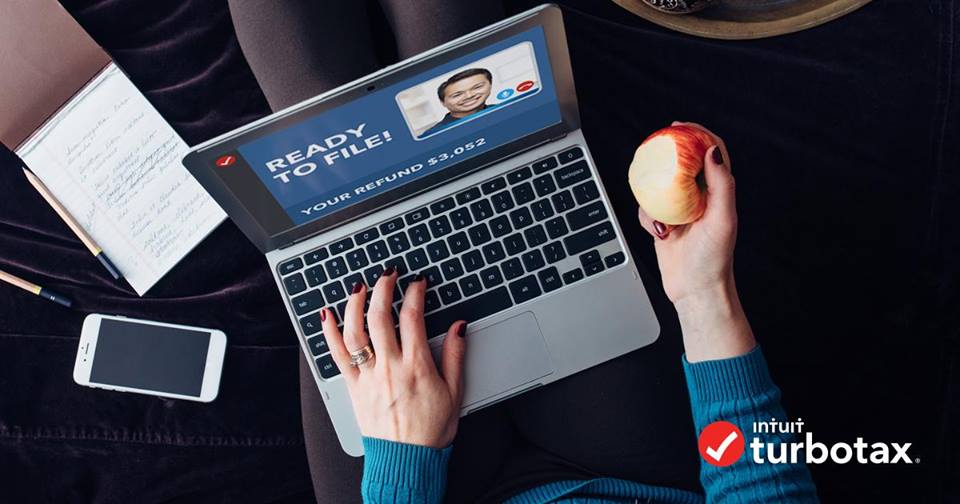 woman holding an apple and a laptop