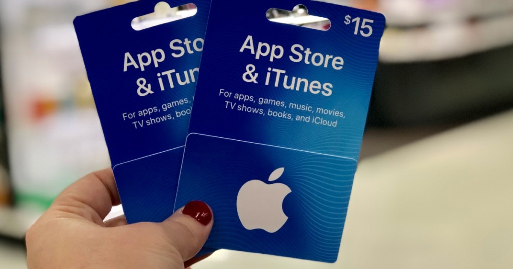 hand holding 2 itunes gift cards