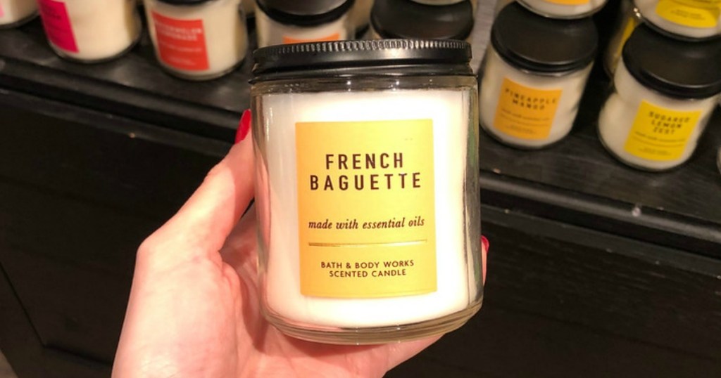 woman holding Bath & Body Works French Baguette Single Wick Candle