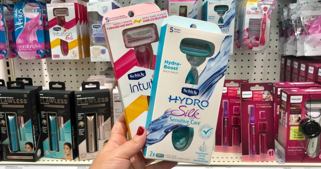 hand holding schick intuition and schick hydro silk razor packs