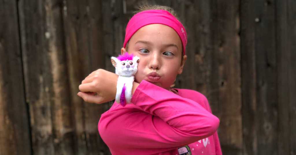 girl with white and pink wrapple on arm outside