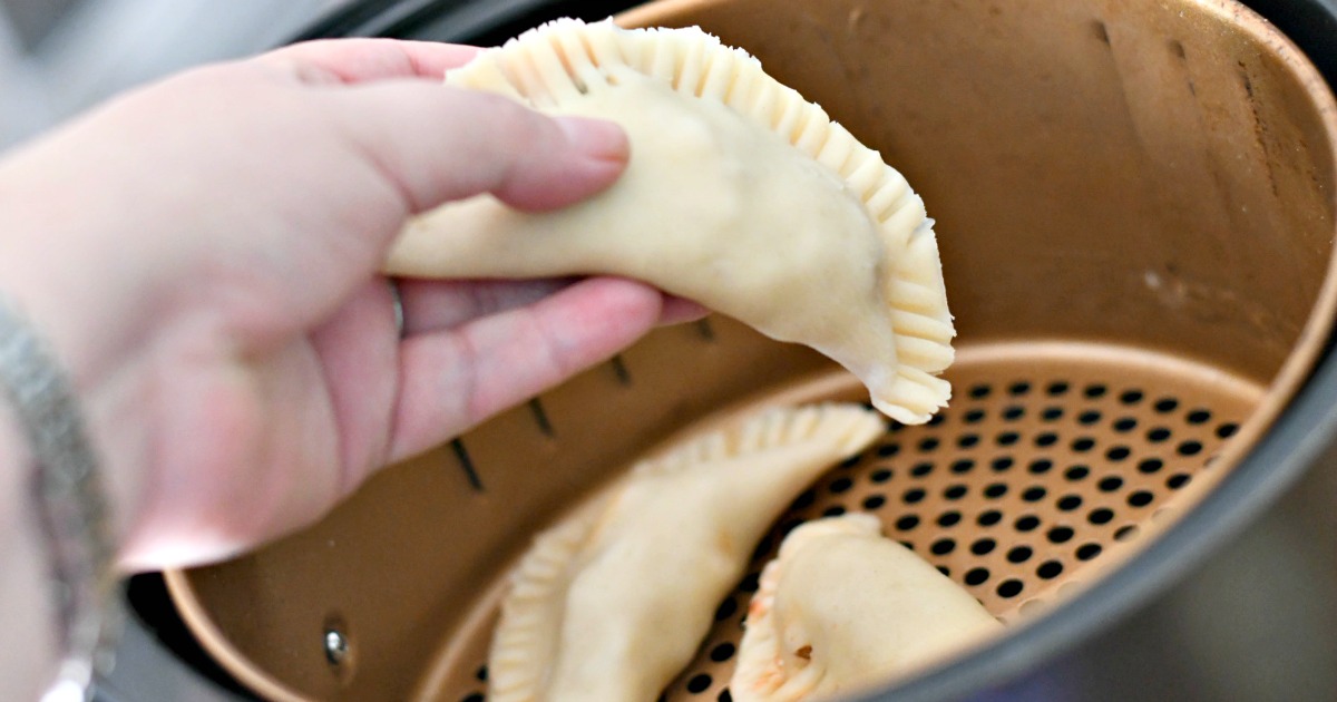 empanadas placed in an air fryer 