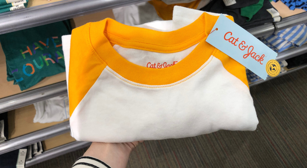 a folded orange and white baseball tee