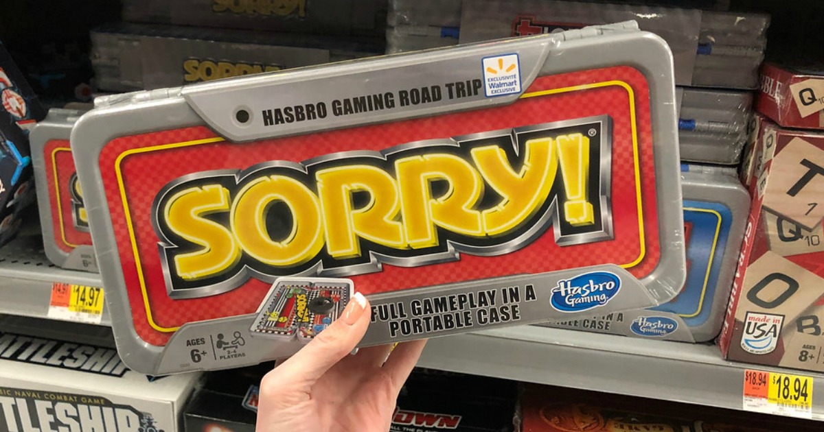 hand holding sorry travel game in front of store shelf