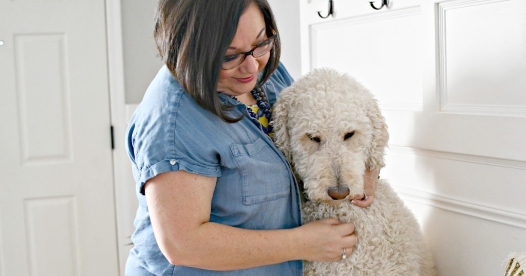 woman hugging a standard poodle 