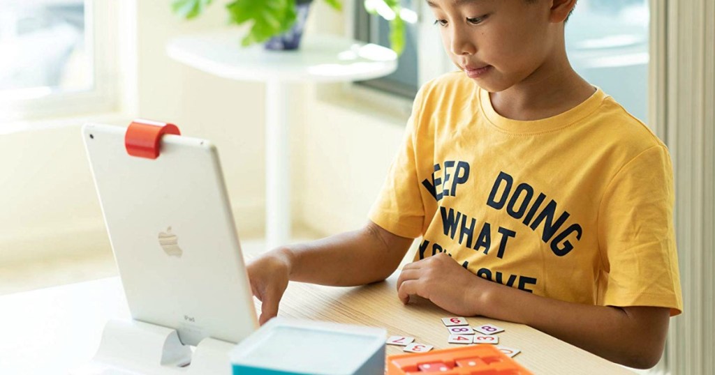 young boy playing with Osmo Genius Kit