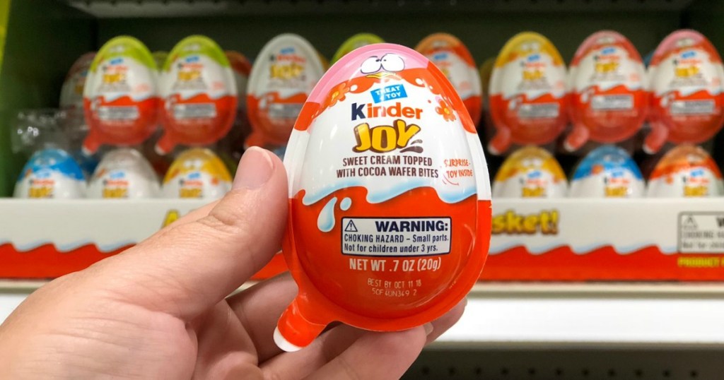 woman holding kinder joy egg