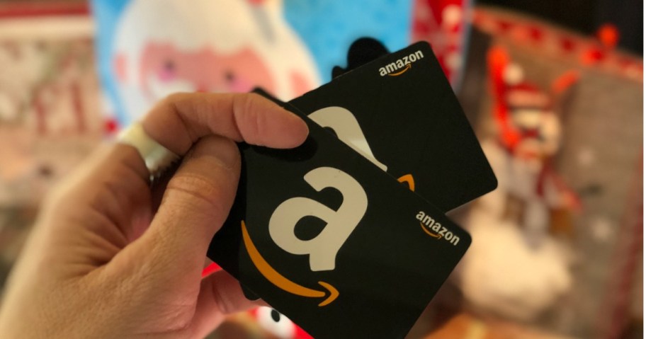 hand holding two Amazon gift cards