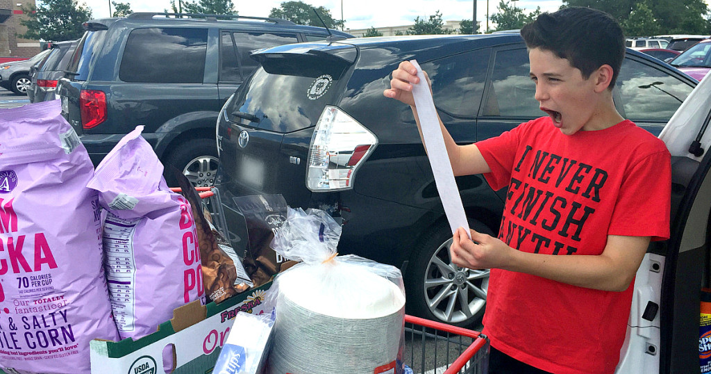 boy holding long Costco receipt in parking lot