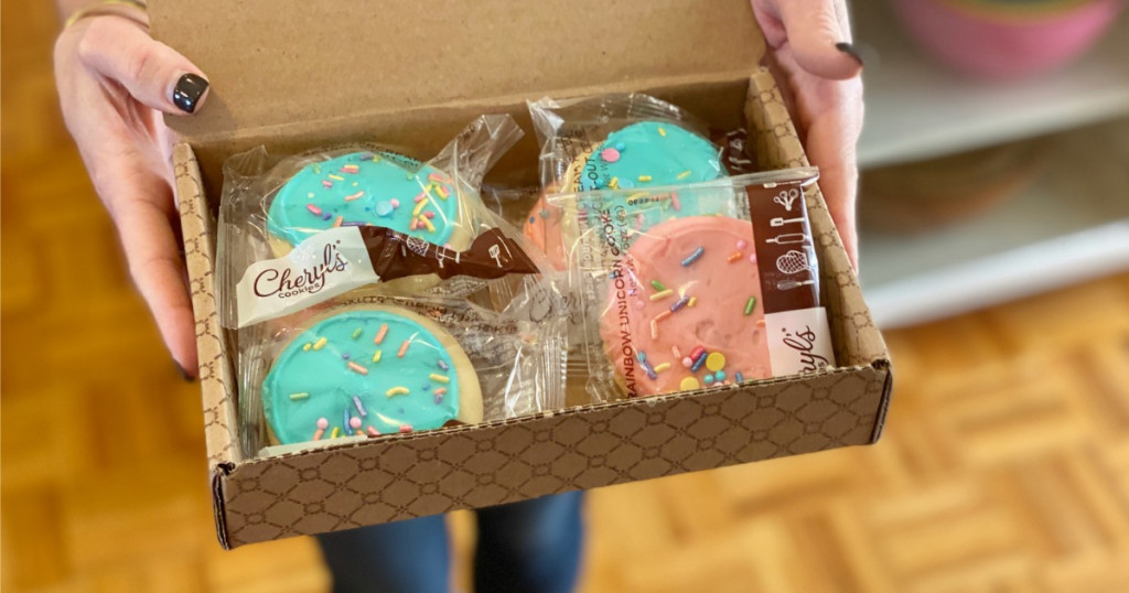 person holding box of cheryl's cookies that we think makes one of the best college care package ideas.