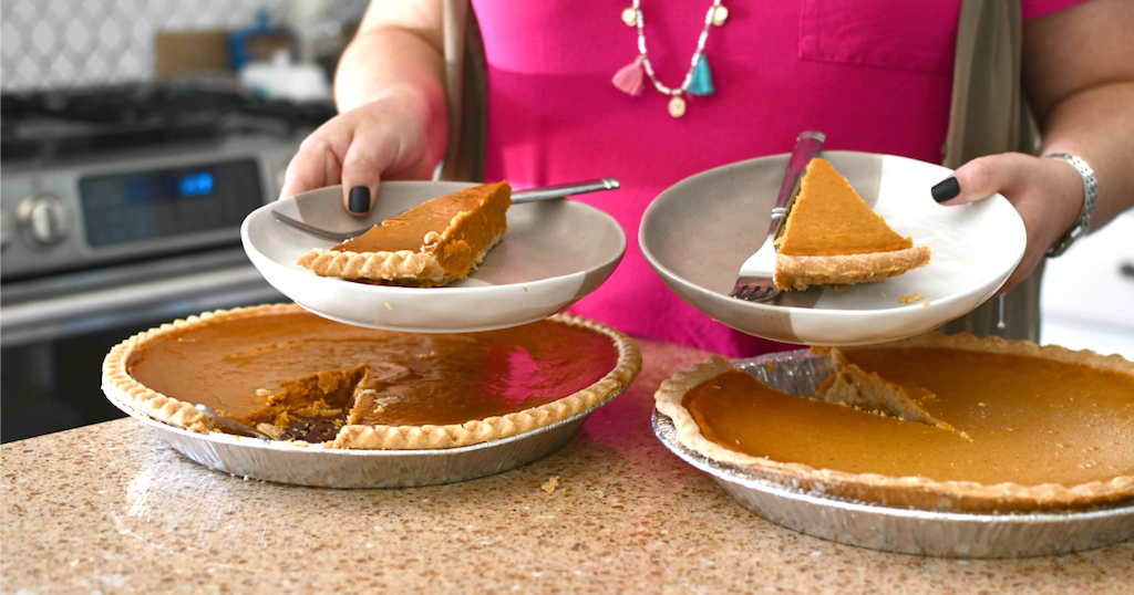 woman holding two different pumpkin pies sams club and costco