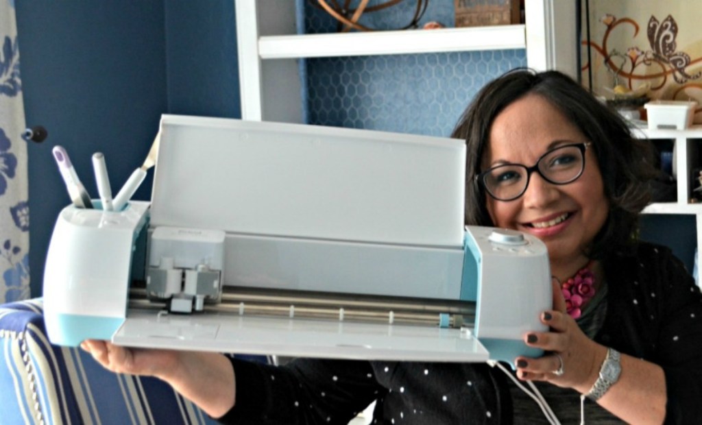woman holding cricut machine