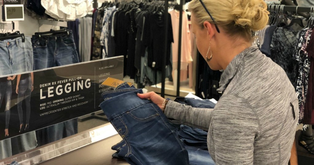 woman holding a pair of Rock & Republic Leggings