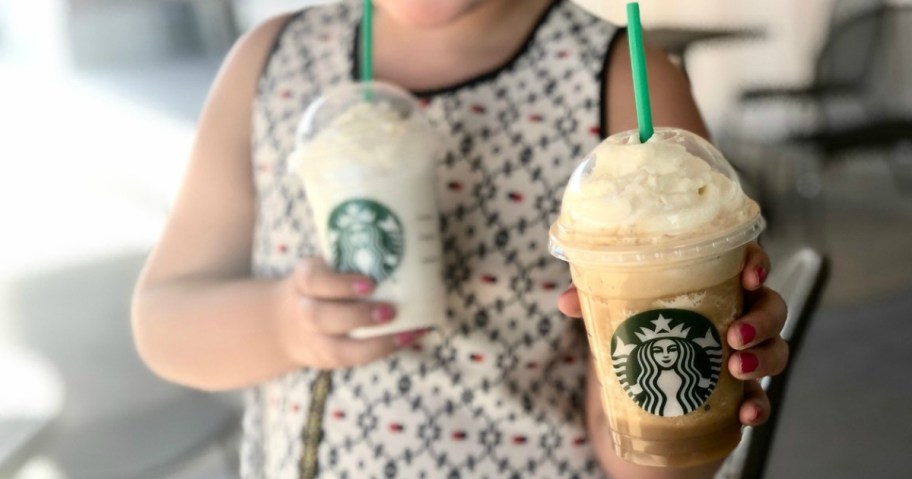 girl holding 2 Starbucks drinks