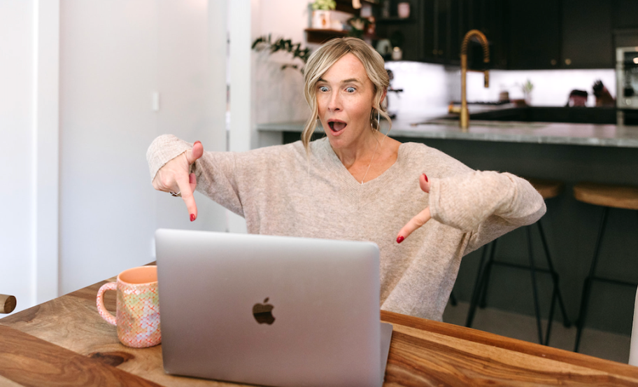 woman pointing to MacBook