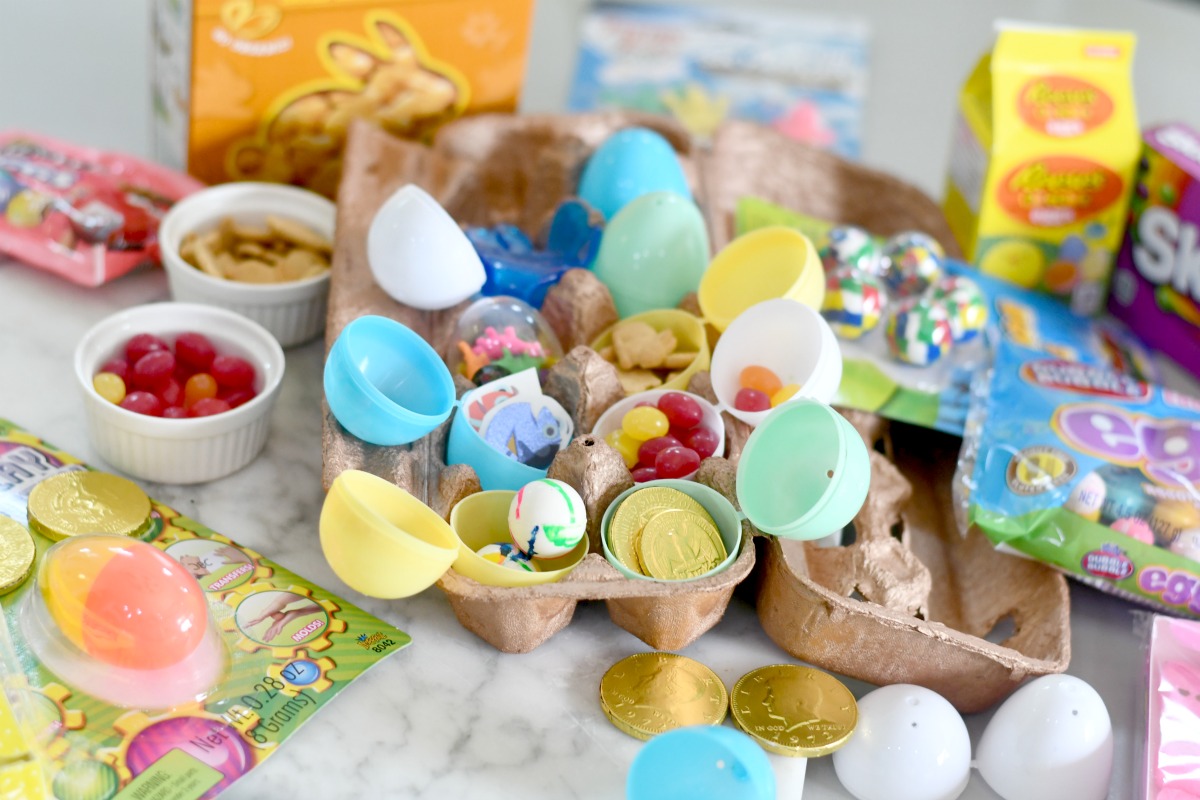 assortment of candy and toy filled plastic eggs in a carton
