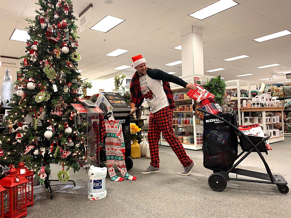 man pulling Kohl's shopping cart in-store