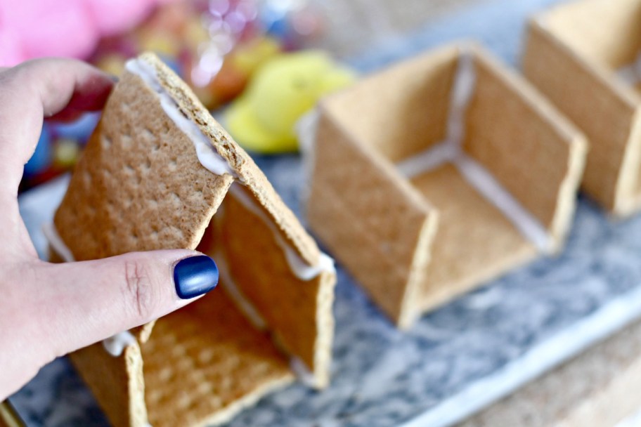 using icing as glue to compile an Easter Peeps house 