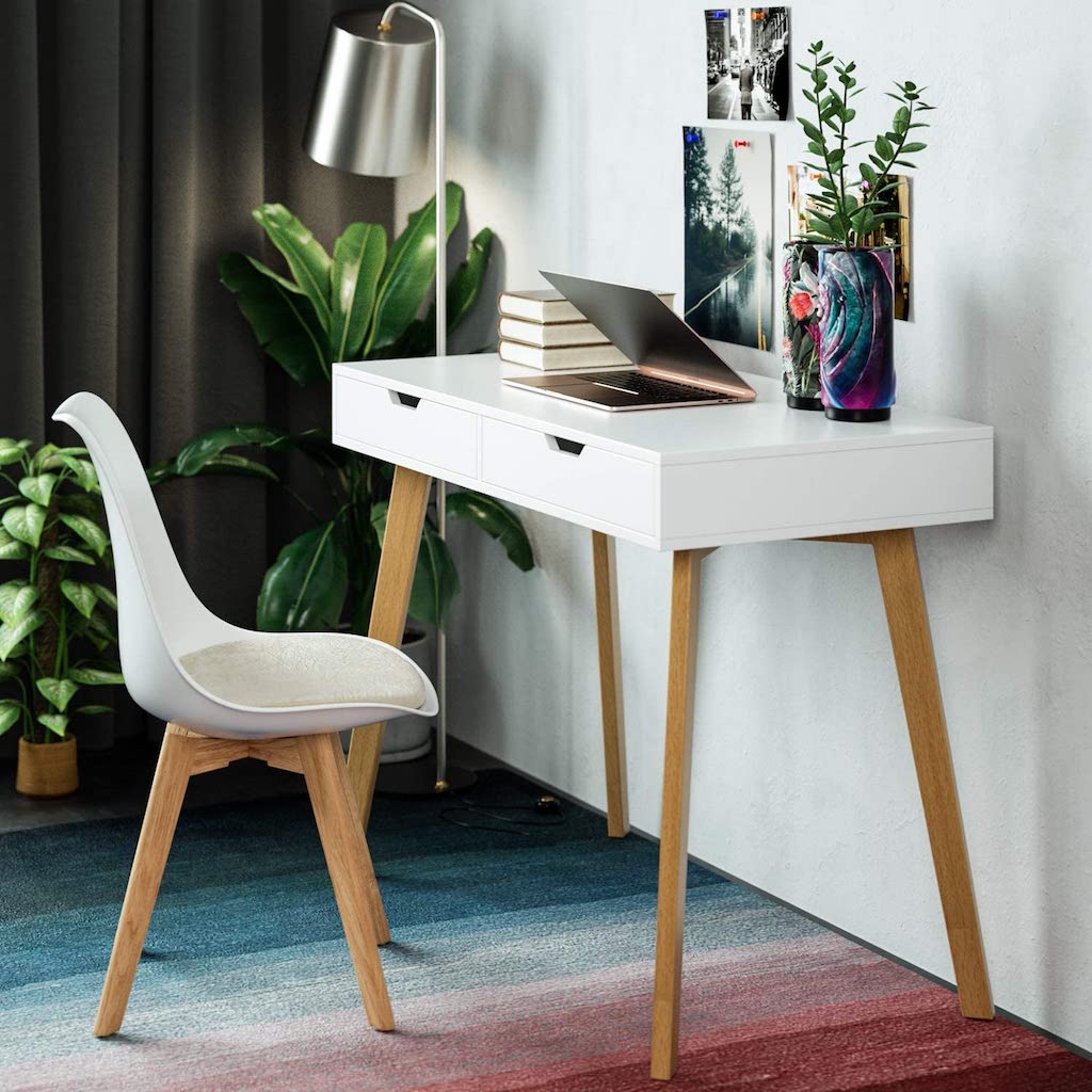 modern desk with laptop and plants 