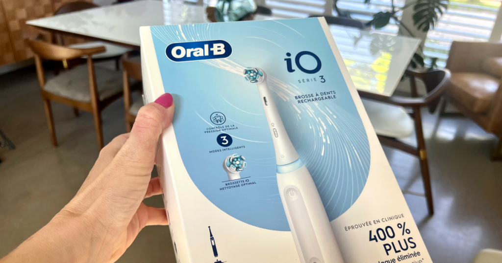 holding oral b toothbrush