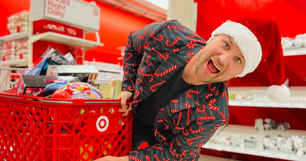 man holding onto target cart full of gifts