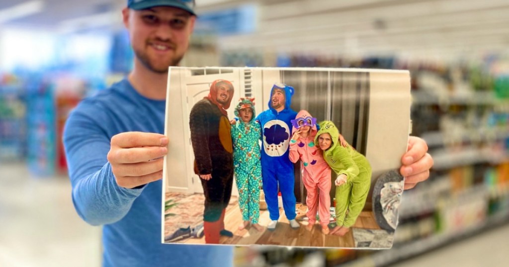 man holding photo print in store